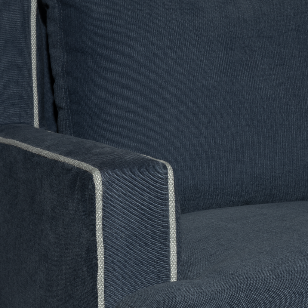 Close-up of a dark blue upholstered chair with a visible stitching detail.