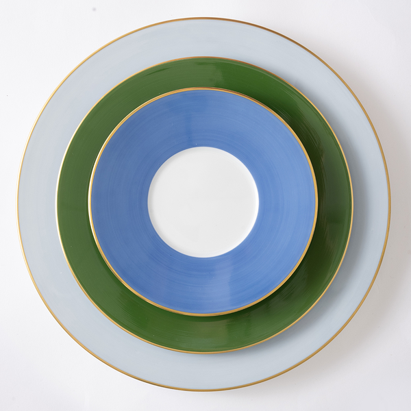 Stack of three ceramic plates with gold rims on a white background