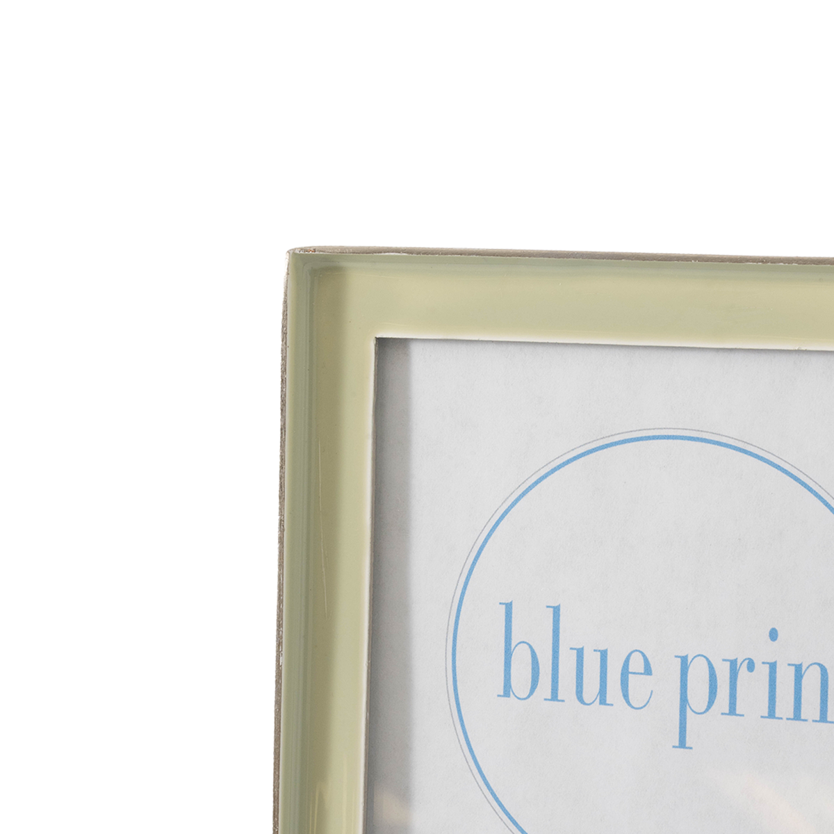 Close-up of a light green picture frame corner with a white print inside featuring blue text and a blue circle outline.