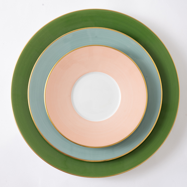 Stack of colorful ceramic plates on a white background