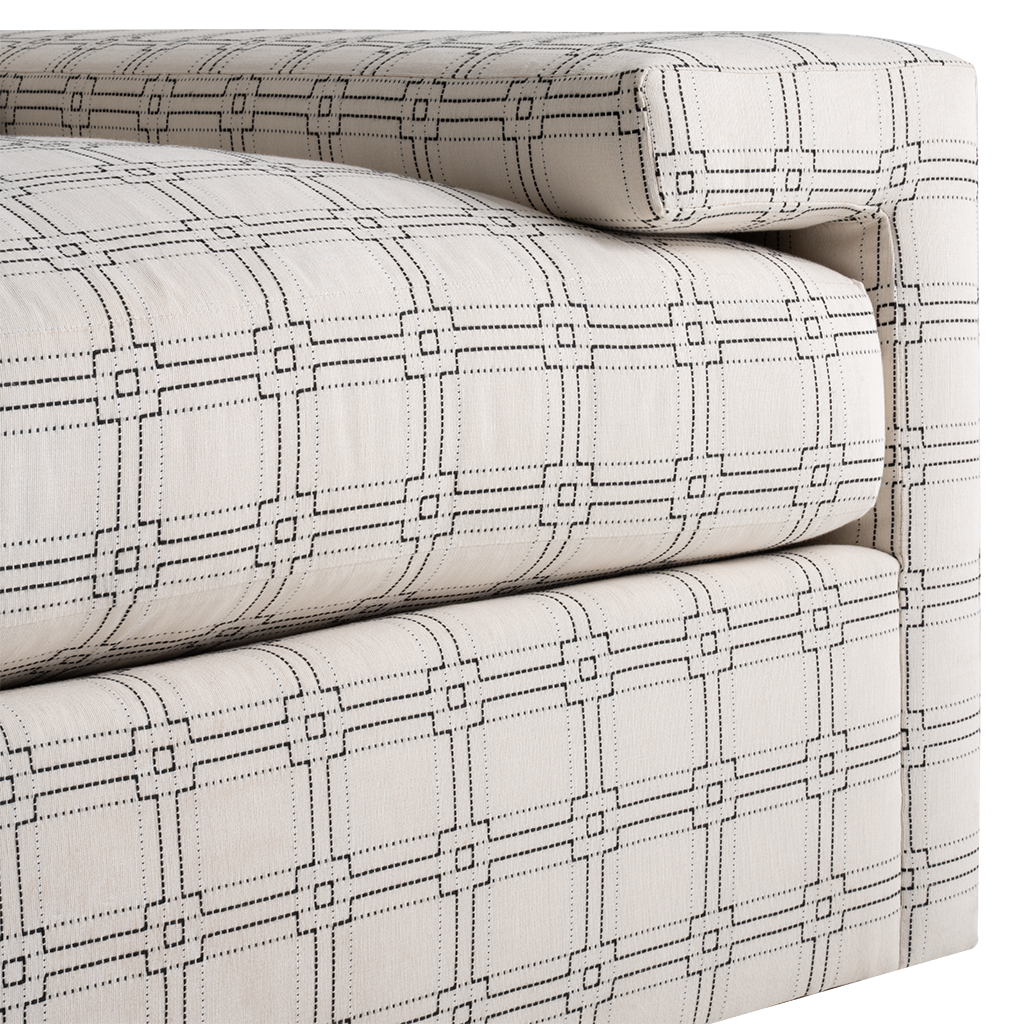 Light beige sofa upholstery with a geometric grid pattern of squares and lines in dark gray.