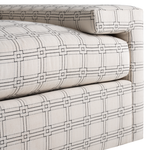 Light beige sofa upholstery with a geometric grid pattern of squares and lines in dark gray.