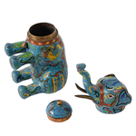 Decorative elephant-shaped teapot with intricate designs on a white background