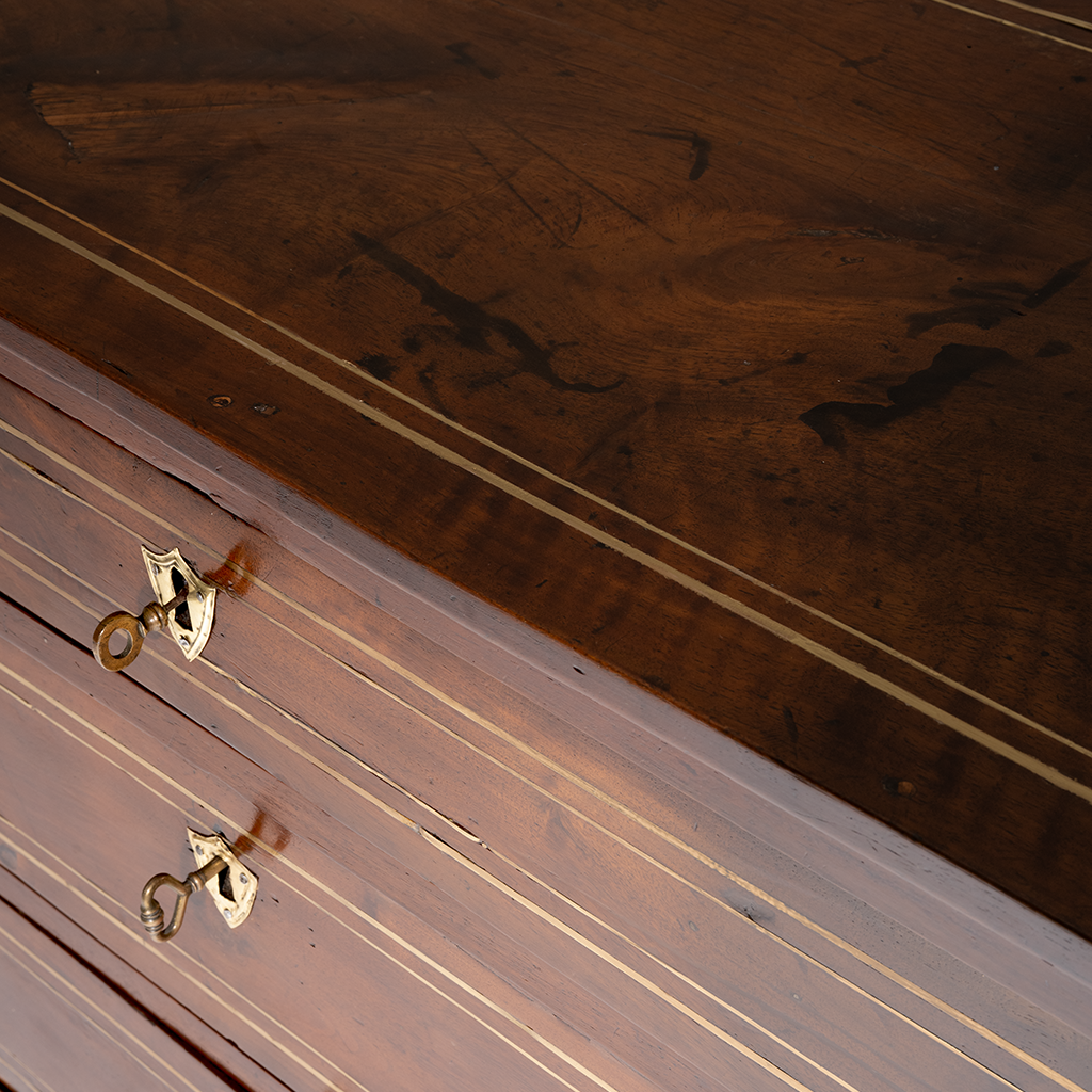 Close-up of a wooden surface with a brass key