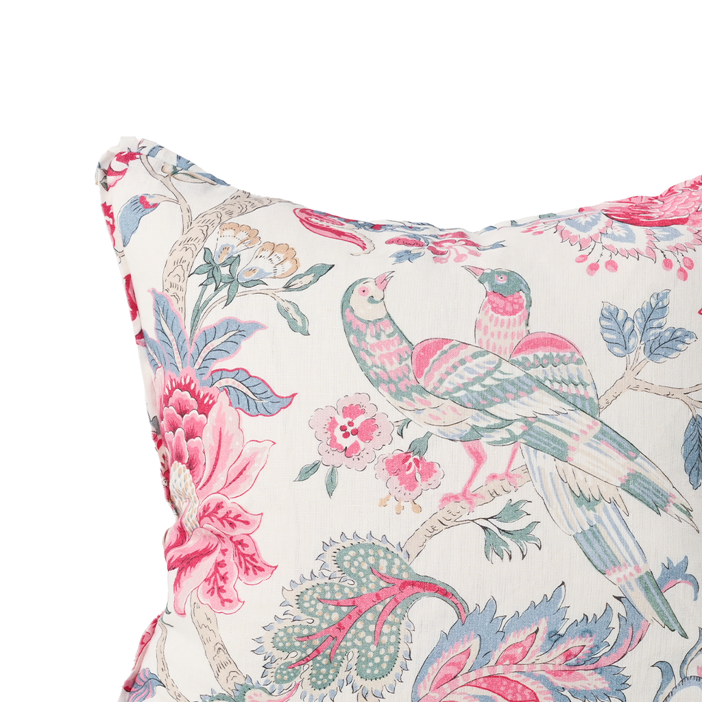 Decorative pillow with floral and bird pattern on a white background