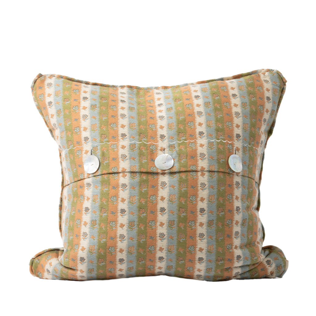 The back of the square decorative throw pillow features the same muted peach, sage green, and ivory striped floral pattern as the front. An envelope-style closure secured with three white buttons provides a classic and functional finishing detail.