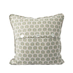 The back of the square decorative throw pillow features the same ivory fabric with a repeating sage green and golden tan botanical pattern as the front. An envelope-style closure secured with three white buttons provides a classic, functional finishing detail.