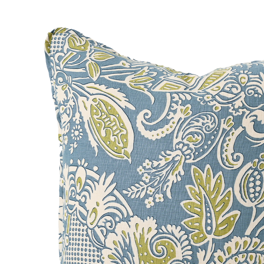 Decorative pillow with a blue and green paisley pattern on a white background