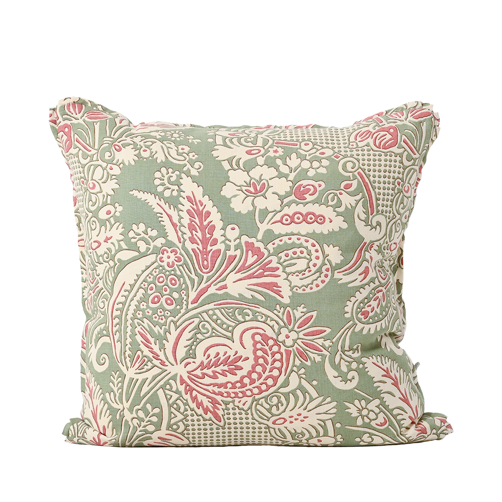 Decorative pillow with pink and white floral pattern on a light green background
