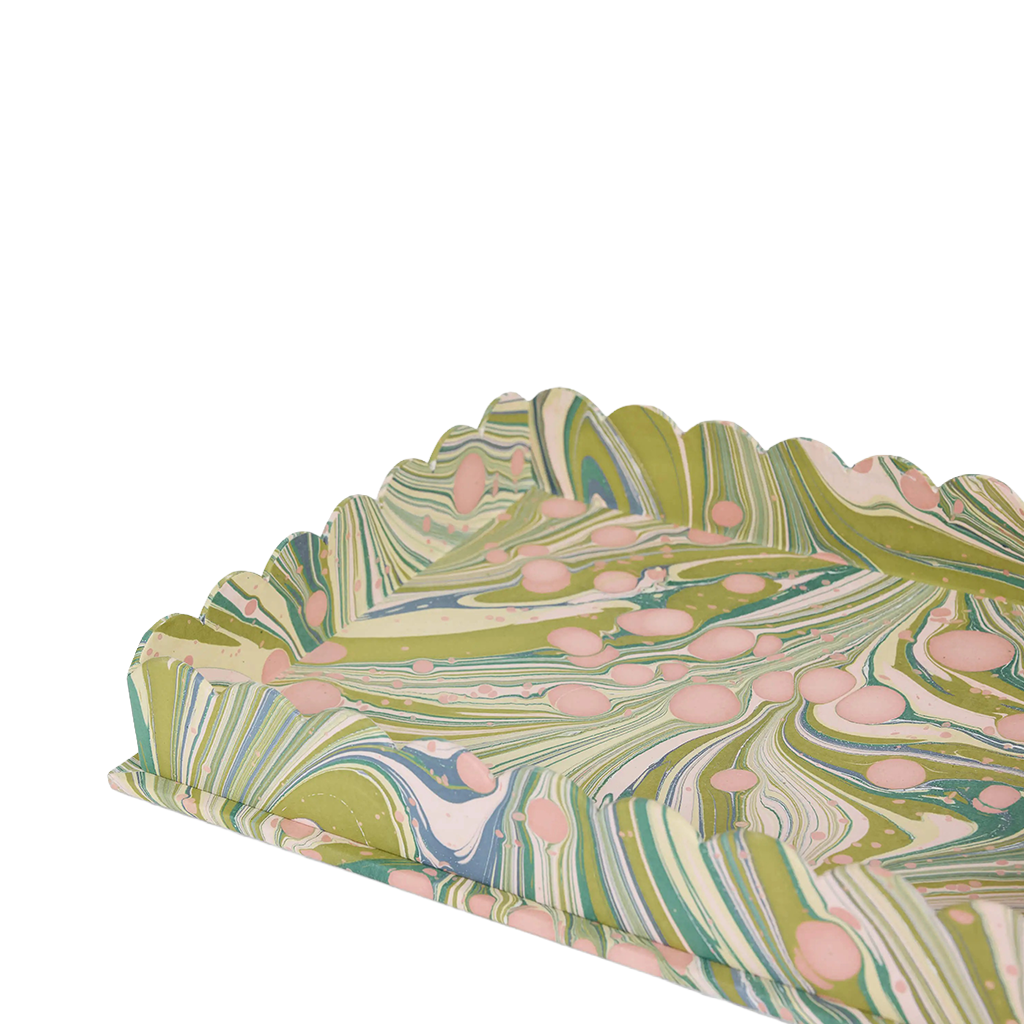 Marbled paper with green, pink, and blue patterns on a white background