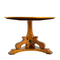Clara Wooden Table with a flat circular top and intricate legs. A view underneath the table