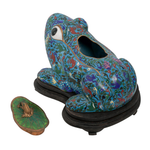 Decorative frog sculpture with intricate patterns on a white background