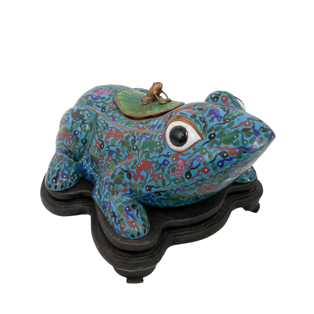 Decorative frog sculpture with intricate patterns on a white background