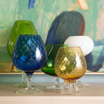 Grouping of vintage colorful vases against abstract art background