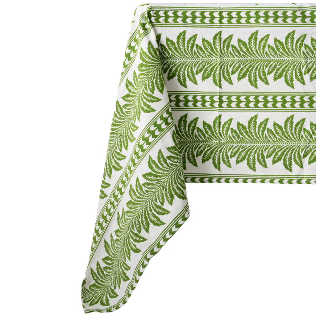 green and white tablecloth with palm tree pattern, draped over a table, on a white background