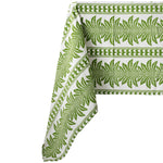 green and white tablecloth with palm tree pattern, draped over a table, on a white background