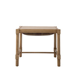 Rear view of the Hank Cocktail Table Ottoman highlighting the natural wood frame and plaid upholstered cushion. Straight wood legs and stretchers create a simple, open silhouette.