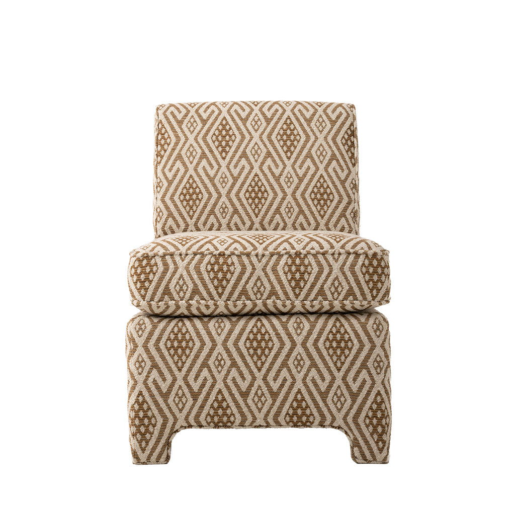 Armless accent chair upholstered in a warm brown and cream geometric fabric. The chair features a cushioned seat, straight upholstered back, and fully upholstered base with curved legs.