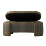 Front view of the upholstered plaid bench with its hinged seat lifted to reveal a hidden storage compartment. The bench features muted green, brown, and rust plaid upholstery with substantial rounded legs at each end.