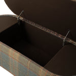 Close-up of the bench with the hinged seat lifted to reveal a spacious, dark-lined interior storage compartment. Metal support hinges hold the upholstered lid open, highlighting the bench’s hidden storage functionality.
