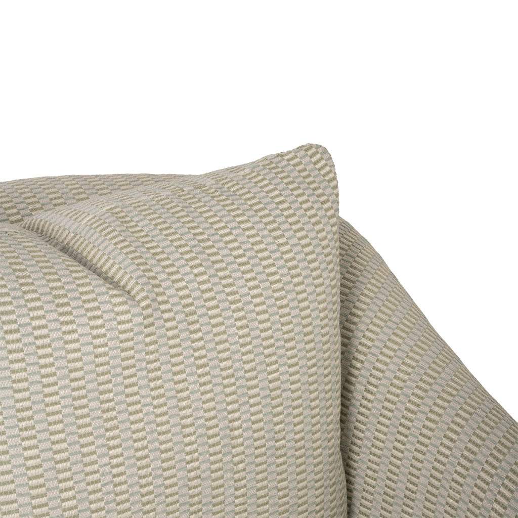 Close-up of the chair’s cushion and upholstery, highlighting the subtle woven texture and small-scale geometric pattern. The warm cream color creates a soft, neutral look.