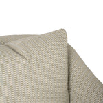 Close-up of the chair’s cushion and upholstery, highlighting the subtle woven texture and small-scale geometric pattern. The warm cream color creates a soft, neutral look.