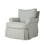 Three-quarter view of the armchair showing its plush back cushion, rounded arms, and deep seat. A subtle gray and cream geometric fabric covers the chair from top to bottom.