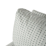 Close-up of the chair upholstery showing the small-scale repeating geometric motif. The soft gray and cream palette gives the patterned fabric a subtle, textured appearance.