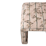 Patterned ottoman with a floral design on a white background