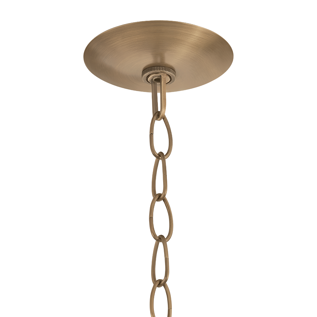 A close-up of a ceiling light fixture's round brushed brass canopy and hanging chain against a plain white background.