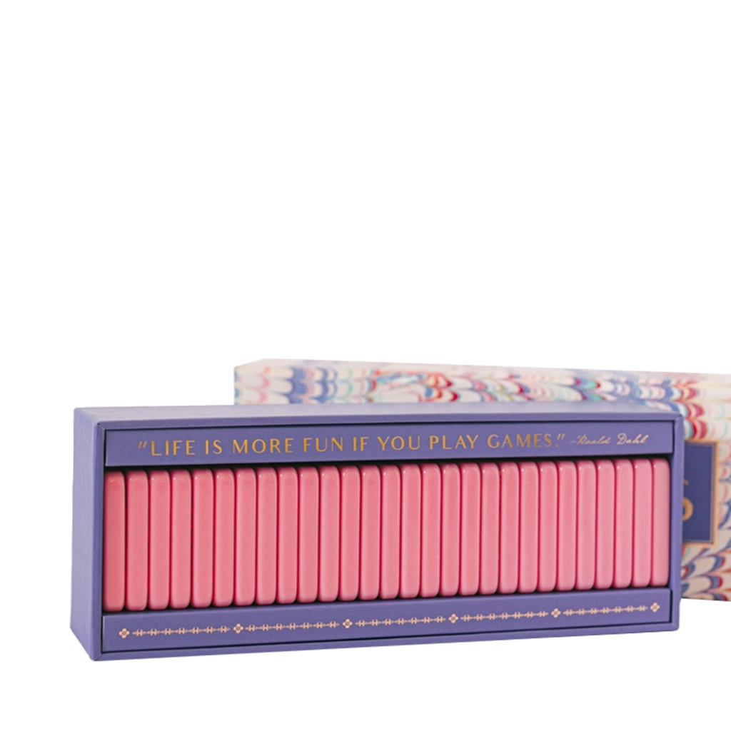 Box of pink dominoes with decorative design and text on a white background