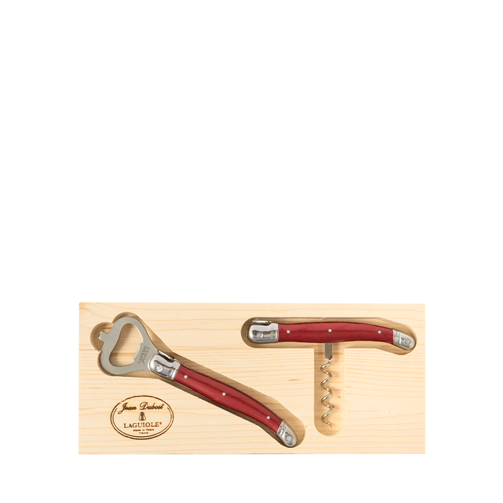 Set of red-handled corkscrew and bottle opener on a wooden display block with Laguiole logo.