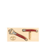 Set of red-handled corkscrew and bottle opener on a wooden display block with Laguiole logo.