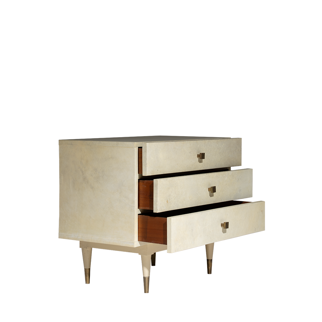 Three-drawer chest with brass handles on a white background