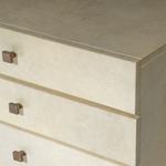 Close-up of a chest with bronze knobs.