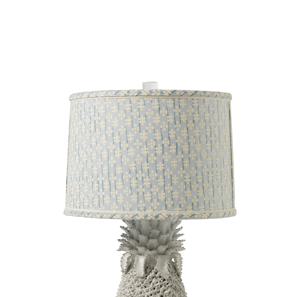 Pineapple-shaped lamp with a patterned shade on a white background