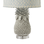 Pineapple-shaped table lamp with a patterned lampshade on a white background