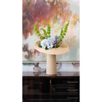 Raffia lapel vase on a console with abstract art and floral arrangment