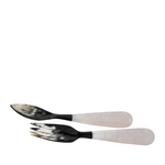 Set of two serving pieces with black and white handles on a white background
