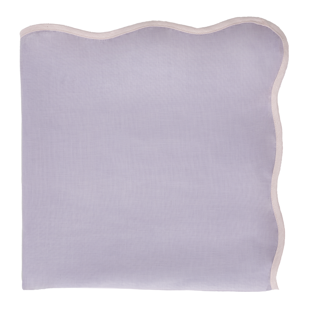 Light purple table topper with a scalloped edge on a white background
