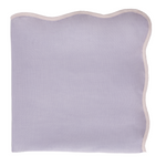 Light purple table topper with a scalloped edge on a white background