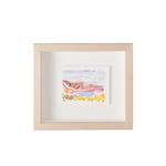 A framed art print featuring a colorful watercolor illustration of a fish on a white background, housed in a light natural wood frame with a white mat.