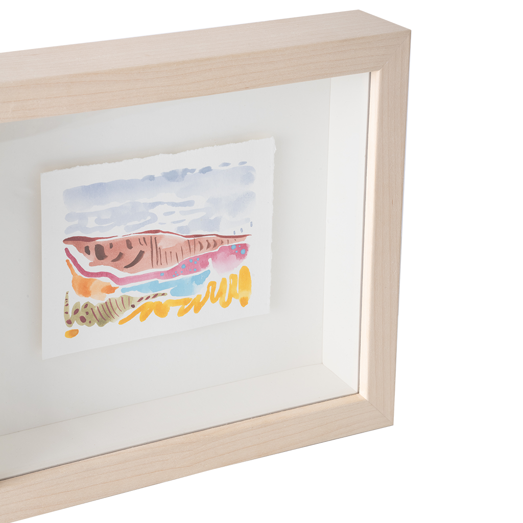 A framed abstract watercolor art print in a light natural wood shadowbox frame, shown against a clean white background.
