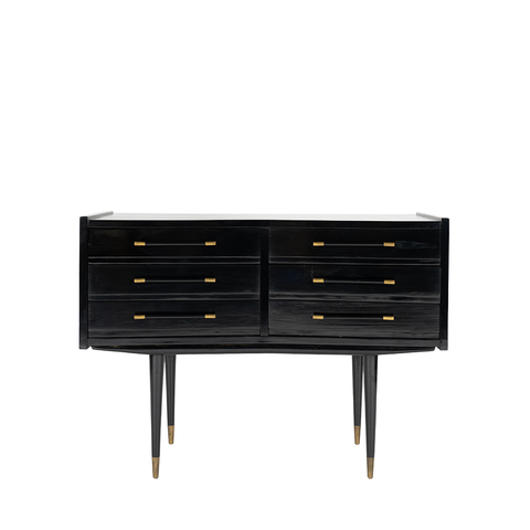A vintage black chest with black and gold handles on each of the 6 drawers