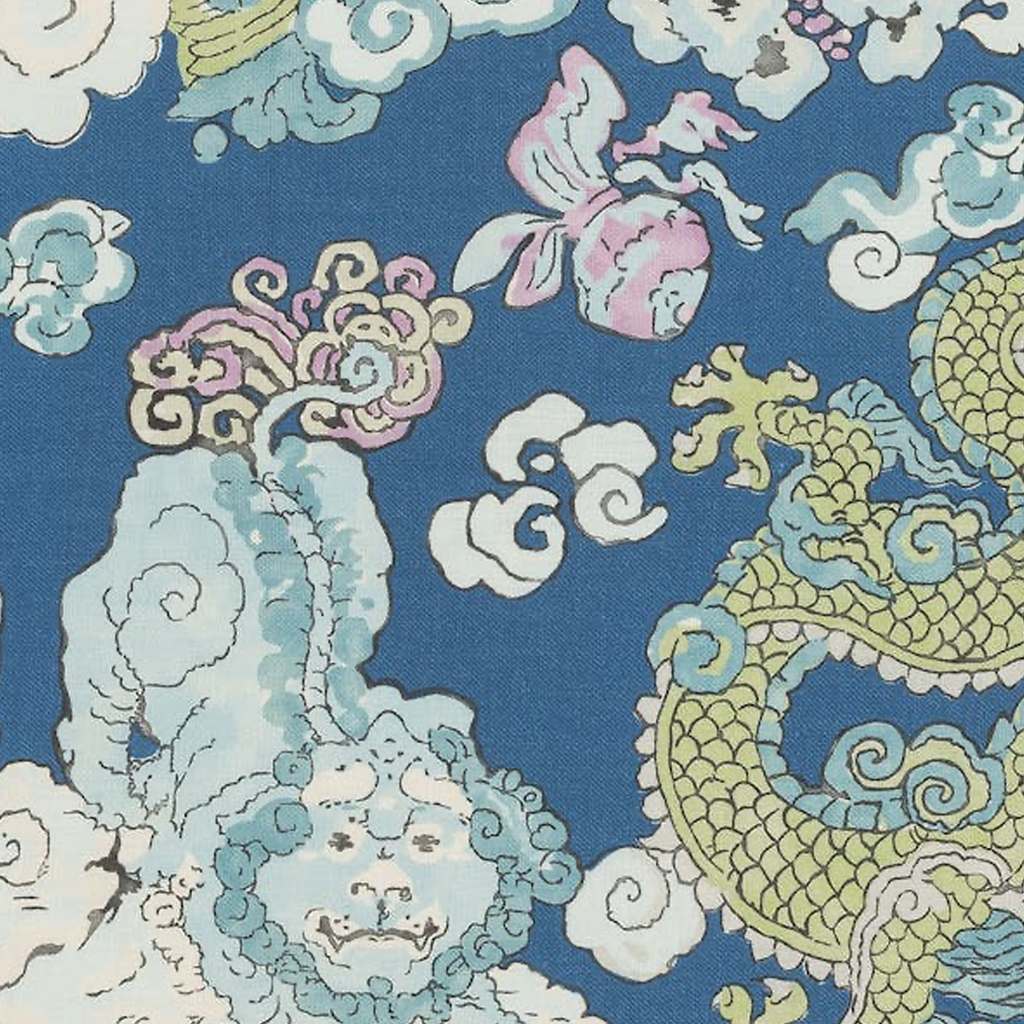 Blue tablecloth with whimsical gold dragon, lotus flowers, and cloud motifs in pastel shades.