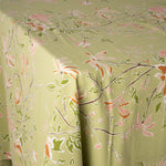close up image of a green and orange botanical tablecloth