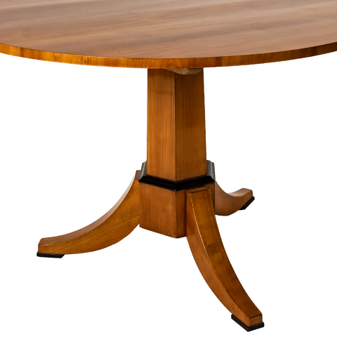 Maria Wooden Table. A circular flat top with 3 legs stemming from the bottom. A very classic design. A view of the legs alone