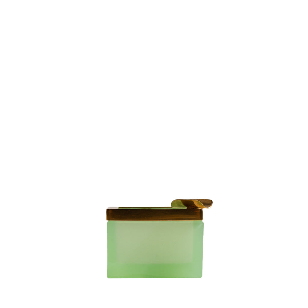 A small collectible frosted green rectangular container with a wooden lid and scoop sits on the Petite Antique Opaline Tray, Melon, against a plain white background.