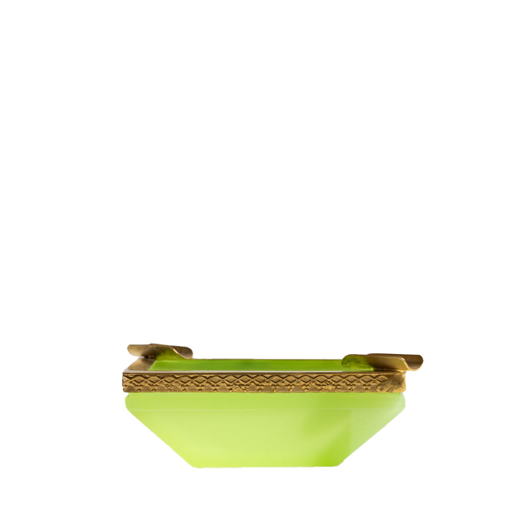 A small, rectangular lime-green opaline glass box with a gold rim and hinge sits on a plain white background—an elegant piece echoing the style of the Antique Opaline Tray, Lime.