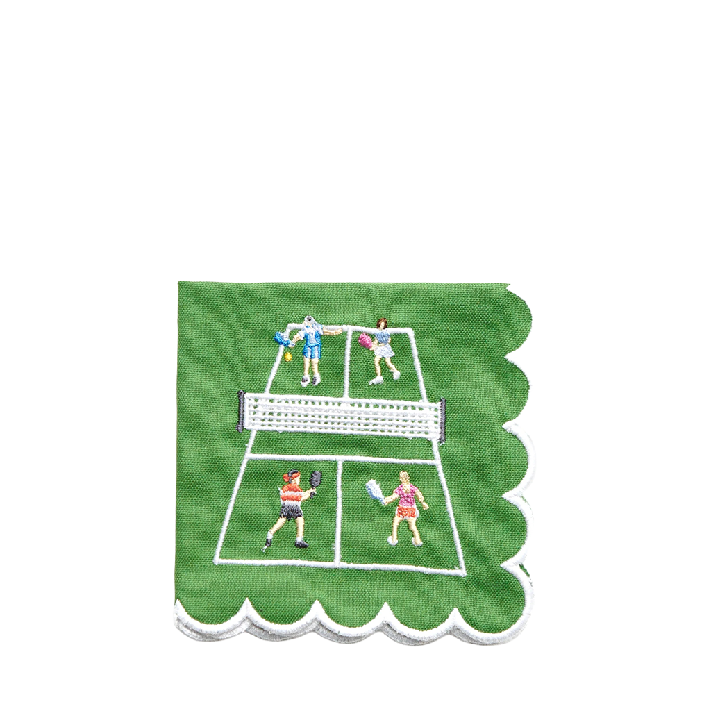 A square green napkin with scalloped edges, featuring an embroidered tennis court design with players in colorful outfits on a white background.